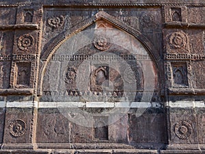 Ancient artistic Islamic architecture on stone wall