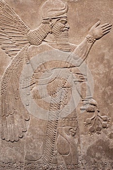 Ancient assyrian winged god photo