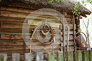 Ancient authentic belarussian wooden hut, wall detail with retro self-made household