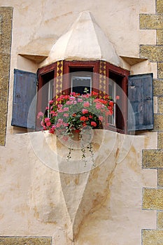 Ancient balcony with windows and flowers - Ardez village Engadine Switzerland