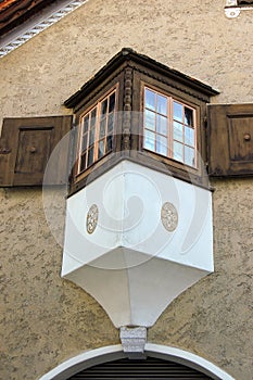 Ancient balcony with wooden windows in Engadine valley Switzerland