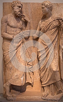 Ancient bas-relief on funerary stele from Kerameikos in Athens, Greece depicting standing man and woman