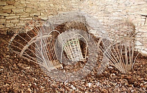 Ancient baskets ( Alpine Gerla ) on the floor of a hut.