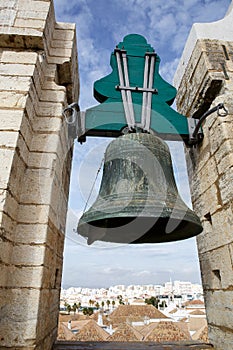 Ancient big bell above small european town.