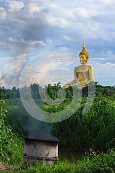 Ancient Big Buddha Image in the Field at Muang Temple , Ang Thong in Thailand