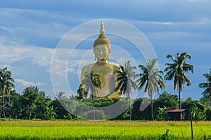 Ancient Big Buddha Image in the Field at Muang Temple , Ang Thong in Thailand