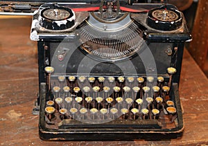 Ancient black rusty typewriter used by typists than once