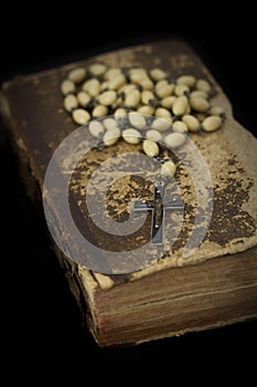 Ancient book with prayer beads