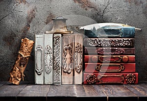 Ancient books, manuscript with a wax seal on the shelf and bronze inkwell with a feather