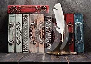 Ancient books on shelf and antique inkwell