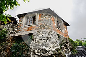 Ancient brick and stone house in cloudy spring afternoon