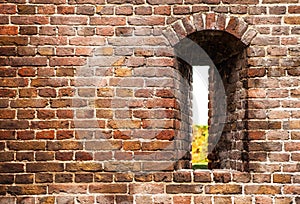 Ancient brick wall of castle with loophole as background