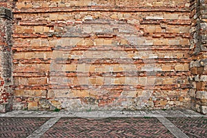 Ancient brick wall and paved sidewalk