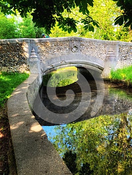 An ancient bridge over a calm river