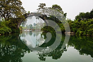 Ancient bridge over Yulong river at Yangshuo photo