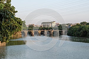 Ancient bridges and forests on the river at dusk