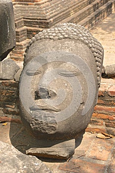 Ancient broken Buddha head with serene expresssion