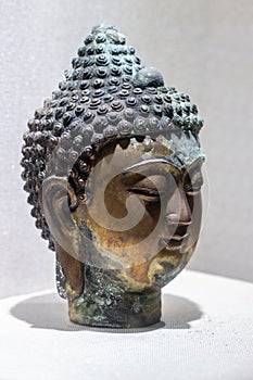 Ancient bronze buddha closeup photo