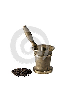 Ancient bronze mortar and a handful of black pepper peas on a white background