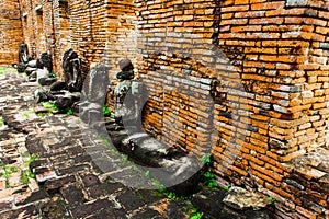 Ancient Buddha statue articulate are red brick wall