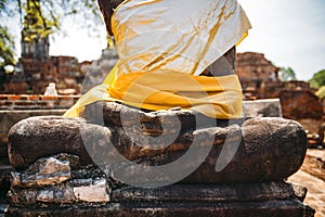 Ancient Buddha statue with shiny yellow robe, in Ayutthaya, Thai