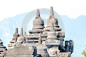 Ancient Buddha statue and stupa at Borobudur temple in Yogyakarta, Java, Indonesia.