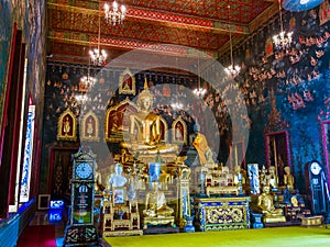 Ancient Buddha statue in Thailand with mural painting around.