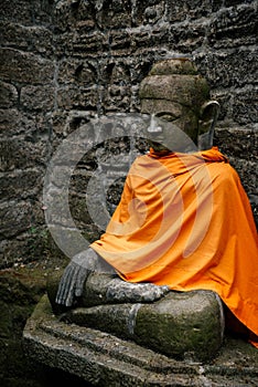 Ancient Buddha statues in orange cover