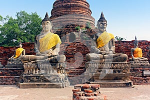 Ancient buddha statues and ruins of Wat Yai Chaimongkol temple in Ayutthaya, Thailand.