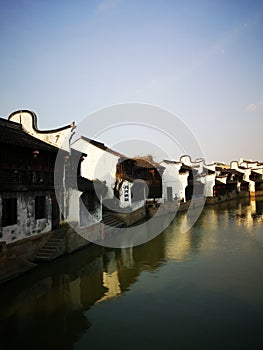 Ancient building reflecting on the peaceful river