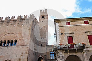 Ancient building with tower near Rimini City Hall on Cavour square in Rimini, Italy