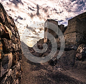 Ancient Calatrava la Vieja castle in Castilla La Mancha, Spain under the cloudy sky photo