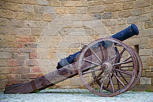 The ancient cannon close-up against the backdrop of the fortress wall of the Old City. Baku, Azerbaijan