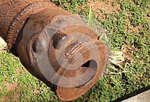 Ancient cannon with head of a man engraved in the bod