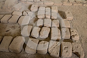 Ancient carved bricks used for construction at Huaca de la Luna archaeological site - Trujillo, Peru