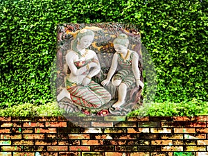 Ancient carving angel green garden ancient brick wall