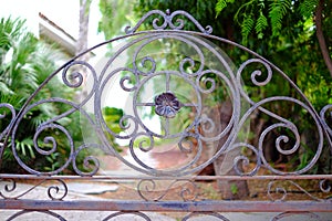 An ancient cast iron gate to a garden.