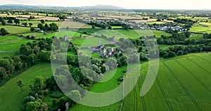 An ancient castle set against a backdrop of green valley in Ireland