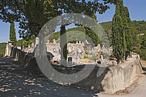 An ancient cemetery with old and new graves in the historic village of Le Poet Laval in the Drome region of the South of France