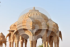 Ancient cenotaph with modern windmills in bada baag Jaisalmer Rajasthan India