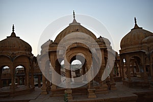 Ancient cenotaph with modern windmills in bada baag Jaisalmer Rajasthan India