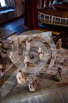 Ancient Chess pieces on a strategic map in the Bridge Tower, London