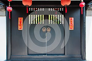 Ancient Chinese black door decorate with hanging lamps