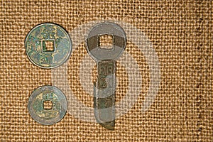 Ancient Chinese bronze coins on old cloth