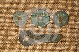 Ancient Chinese bronze coins on old cloth