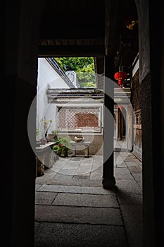 Ancient Chinese entranceway and courtyard with green vegetation photo