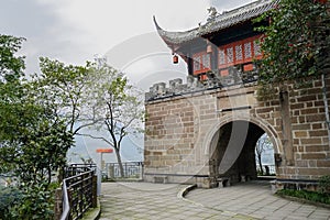 Ancient Chinese gate on mountaintop in cloudy winter afternoon