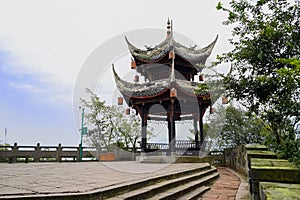 Ancient Chinese gazebo on mountaintop viewing platform in cloudy