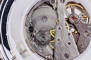 Ancient chronometer mechanism cogs gears wheels connection. Antique pocket watch clock