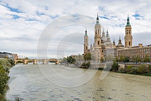 The ancient church Basilica del Pillar and bridge near the river Ebro in the Spanish city Zaragoza